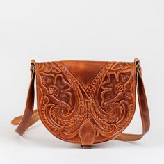 Hand made leather tooled purse with the best quality of 100% genuine cowleather. This women saddle bag has two different spaces inside to put your essentials as well as a zipped pocket for your personal belongings. The outer strap is adjustable for your shoulder. The perfect a gift which wil make a woman stand out for her aesthetics in her every day life. All of our products are handmade with the best and highest quality leather from our beloved island of ''Crete''. The leather used for each ite Vintage Tooled Leather Purse, Saddle Bag Purse, Crossbody Leather Bag, Tooled Leather Bag, Tooled Leather Purse, Western Purses, Embossed Bag, Leather Saddle Bags, Purse For Women