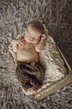 a baby is laying down on a blanket