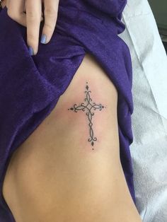 a woman with a cross tattoo on her stomach