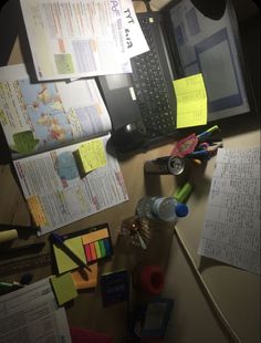 a cluttered desk with many papers on it