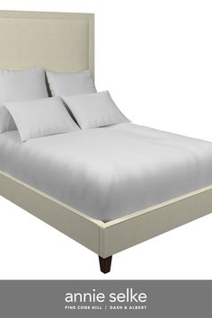 an image of a bed with white sheets and pillows