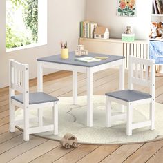 a child's table and two chairs in a room