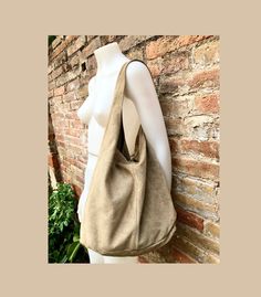 Slouch bag in beige suede. Genuine leather LARGE tote bag. Soft suede shopper bag. NOT LINED. We added a small leather zipper pouch for your mobile phone and/or cards or money. It ist attached to the inside of the bag by a metal chain. Leather carry all bag, large enough for most laptops, tablets, books etc. The bag is closed by a metal clip at the center. Width : 42cm - 16,5 in Height at the center: 34 cm - 13, 5 inc Total height : 65,5 cm - 26 inch This bag in different colors and other leathe Beige Soft Leather Hobo Tote Bag, Beige Soft Leather Hobo Bag For Daily Use, Everyday Hobo Bag With Suede Lining, Everyday Suede Hobo Tote Bag, Suede Hobo Tote Bag With Large Capacity, Versatile Suede Tote Shoulder Bag, Everyday Suede Hobo Bag, Suede Hobo Bag With Removable Pouch For Everyday, Everyday Suede Hobo Bag Shaped As Satchel