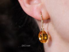 These earrings are composed of the most amazing genuine, natural Madeira Citrines. These red-carpet worthy gemstones are absolutely clean and have an intense golden color. They hang from Solid Gold 14k gold unique earwires that are set with 5 diamonds each. ⭐ DETAILS: ✓ Length including earwires: 1.4″ (about 3.5 cm) ✓ Gold: All the [...] Elegant Oval Citrine Earrings, Citrine Earrings, Natural Citrine, Golden Color, Oval Diamond, Citrine, Red Carpet, Solid Gold, Carpet