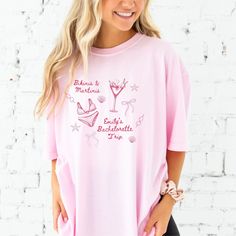 Sip in style with our Personalized Bikinis and Martinis Comfort Colors T-shirt! Perfect for martini lovers and bachelorette trips, this tee is a must-have for any bridal party or cocktail enthusiast. Make sure to size up for that cozy oversized fit!  Jada is wearing a X-Large blossom tee with watermelon ink in the first photo.  Jada is wearing a X-large white tee with terracotta ink in the second photo. Jada is wearing a large ivory tee with olive ink in the third photo.  Jada is wearing a large Casual Pink T-shirt For Bachelorette Party, Relaxed Fit Cotton Party Tops, Relaxed Fit Cotton Tops For Party, Casual Short Sleeve Tops For Bachelorette Party, Casual Crew Neck Top For Bachelorette Party, Cotton Tops With Letter Print For Bachelorette Party, Cotton Graphic Print T-shirt For Bachelorette Party, Cotton T-shirt For Bachelorette Party, Casual Short Sleeve T-shirt For Bachelorette Party