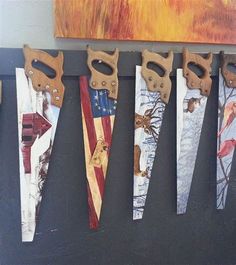 several different types of scissors are hanging on a wall with an american flag painted on them