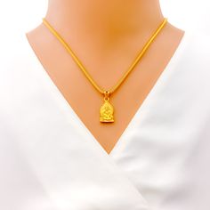 This attractive pendant, exquisitely crafted from 22k gold and weighing 3.2 grams, features a finely engraved depiction of Sai Baba set against a luminous yellow gold finish. The pendant has a length of 0.9 inches, making it both noticeable and modest in size, ideal for daily wear. Perfect for devotees who wish to keep Sai Baba close to their hearts, this pendant combines spiritual devotion with elegant craftsmanship, offering a timeless piece that embodies grace and serenity. PRODUCT DETAILS Gold Purity(karat): 22k Gold Weight(grams): 3.2 Item Finish: Yellow Gold Pendant Length: 0.9" Chain: Not Included Gold Locket Jewelry For Diwali, 22k Gold Hallmarked Temple Necklace Pendant, Gold Pendant Temple Necklace For Diwali, 22k Gold Locket Necklace In Temple Jewelry Style, 22k Gold Locket Temple Necklace, 22k Gold Temple Necklace With Locket Pendant, 22k Gold Temple Necklace With Locket As Gift, Gold Jewelry Pendant For Diwali, 22k Gold Temple Jewelry Necklace As Gift