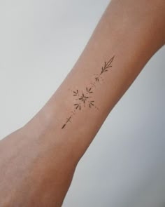 a woman's arm with a small tattoo on it