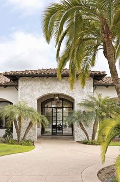 a house with palm trees in front of it