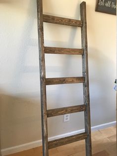 an old wooden ladder leaning against the wall