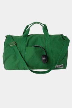 a green duffel bag with headphones on it