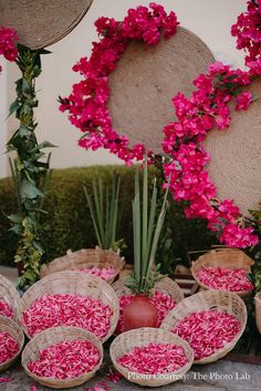 baskets filled with pink flowers sitting on top of a table