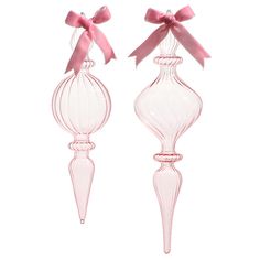 two pink glass vases with bows on them