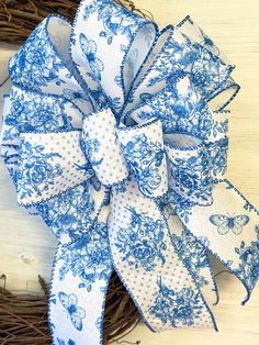 a blue and white bow on a wreath