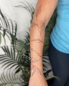 a woman with a flower tattoo on her arm