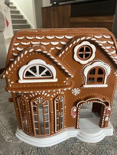 a large gingerbread house with windows and shutters