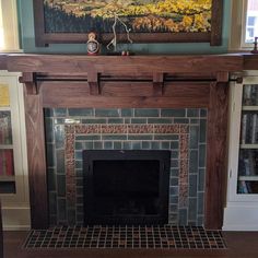 a fireplace in a living room with a painting on the wall above it's mantle