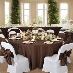 a banquet table set up with white chairs and brown cloths for an elegant dinner