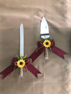 two forks decorated with sunflowers and ribbons