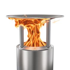 an outdoor fire pit is shown with flames coming out of the top and bottom part