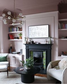 a living room filled with furniture and a fire place