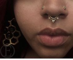 a woman with piercings on her nose