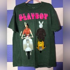 New Without Tags Officially Licensed Shirt On Quality Green Shirt With Distressed Coloring And Contrast Stitching. I Believe It’s Mid Weight Graphic Is Of The Playboy June 1959 Cover Of A Bunny And Woman Passing Each Other On Motorbikes. This Shirt Is A Misprint - The Graphic Was Printed On Front And Back, And On The Front Was Double/Triple Printed Creating A Ghostly Duplicative Effect. There Are Also Touches Of Color Across The Shirt From The Misprint (A Little Red On The Shoulder, Little White Green Cotton T-shirt By Urban Outfitters, Urban Outfitters Green Cotton T-shirt, Vintage Graphic Print Top From Urban Outfitters, Vintage Graphic Print Tops Urban Outfitters, Vintage Urban Outfitters Graphic Top, Urban Outfitters Vintage Graphic Print Top, Vintage Urban Outfitters T-shirt For Summer, Urban Outfitters Retro Graphic T-shirt, Urban Outfitters Retro Graphic Print T-shirt