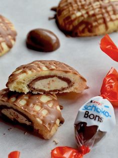 chocolate covered waffles and candies are on the table next to each other