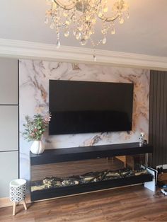 a large flat screen tv mounted to the side of a wall in a living room