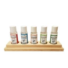 four small jars are sitting on a wooden tray with three different colored inks in them