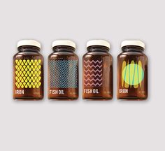 four jars of fish oil with different patterns on the lids and sides, all lined up against a gray background