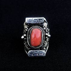 Red coral set on sterling silver traditional Tibetan saddle ring  The ring is nick-named "saddle" because it resembles a yak saddle which is high on both ends. Size ; this ring is adjustable fits sizes 9 to 10 1/2 Hight 34mm  X W24mm Coral measures approximately ; H 15mm x W 10mm  Find more at ; www.BodhiTree.Trendivine.com Western Style Red Jewelry As Gift, Bohemian Red Ring Stamped 925, Handmade Southwestern Red Ring, Artisan Red Sterling Silver Rings, Southwestern Style Red Ring Jewelry, Western Style 925 Silver Rings As Gifts, Western Style Stamped 925 Rings As Gift, Adjustable Red Engraved Jewelry, Red Engraved Adjustable Jewelry