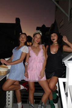 three women dressed in costumes posing for the camera