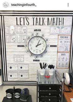 there is a clock on the wall in this classroom with words written all over it