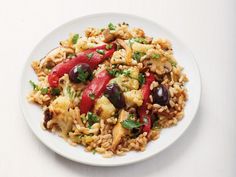 a white plate topped with rice and vegetables