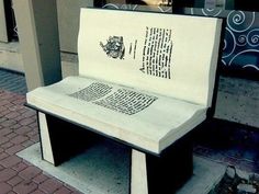 an open book sitting on top of a bench