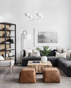 a living room filled with furniture and a painting on the wall above it's windows