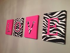 three zebra print wall hangings with the word love on them in pink and black