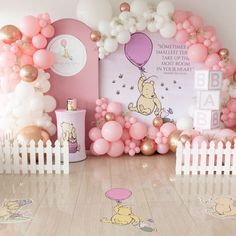 a winnie the pooh birthday party with balloons and decorations