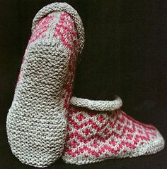 two crocheted slippers sitting next to each other on a black table top