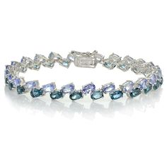 Wear this tanzanite and london blue topaz bracelet as a striking evening or formal accessory. The sterling silver band has a high polish, and it is adorned with two rows of gemstones. This bracelet secures with a safety catch and pressure clasp. Product Details Metal Type sterling-silver Metal Stamp 925-sterling Weight 13.2GR Length 7.5IN Width 12.6MM Clasp Type box-with-tongue Stone Details Gem Type london-blue-topaz Number of Stones 24 Stone Color blue Stone Shape oval-shape Total Weight 5.28 Tanzanite Bracelet, Topaz Bracelet, Blue Topaz Bracelet, Bow Bracelet, Michael Kors Jewelry, Blue Topaz Stone, Bracelet Online, Fine Jewelry Bracelets, Ring Pendant Necklace