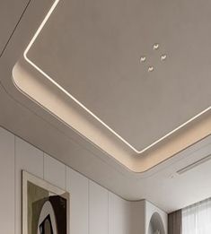 a modern bedroom with white walls and flooring is lit by recessed lighting above the bed