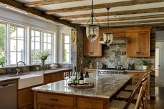 a kitchen filled with lots of counter top space and wooden cabinets next to a window