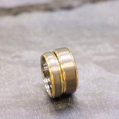 two gold wedding bands on top of each other