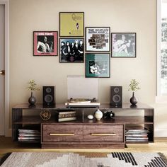 a living room with pictures on the wall and a computer desk in front of it