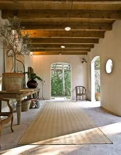 a large room with an area rug and chairs