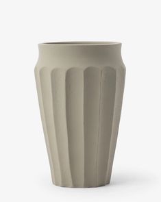 a white vase sitting on top of a table