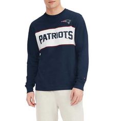 Upgrade your New England Patriots look with this Peter T-shirt. This Tommy Hilfiger tee features bold graphics and a classic design with a team wordmark across the chest. This soft cotton tee is a casual yet stylish choice for game day. Screen print graphics Brand: Tommy Hilfiger Imported Flatlock stitching Officially licensed Machine wash, tumble dry low Long sleeve Material: 100% Cotton Embroidered fabric applique Woven tag Relaxed Fit Long Sleeve T-shirt For Game Day, Collegiate Long Sleeve T-shirt With Relaxed Fit, Varsity Long Sleeve T-shirt For Game Day, Game Day Long Sleeve Graphic Print Top, Game Day Long Sleeve Top With Graphic Print, Fan Apparel Long Sleeve Relaxed Fit T-shirt, Collegiate Long Sleeve Relaxed Fit T-shirt, College Fan Apparel Long Sleeve Tops, Relaxed Fit Long Sleeve Fan Apparel Top