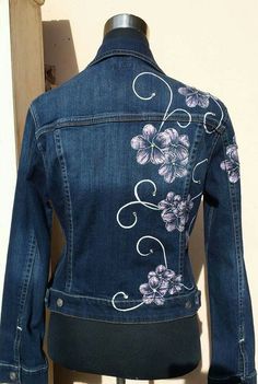 a denim jacket with flowers painted on it