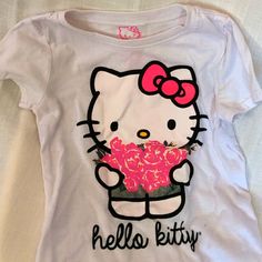 a hello kitty t - shirt with pink roses on it